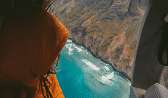 A passenger partaking in one of the safest helicopter tours in hawaii