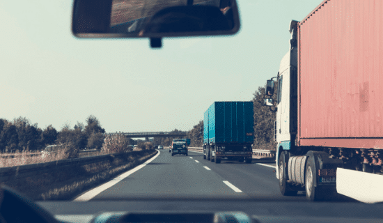 Commercial trucks driving on the freeway