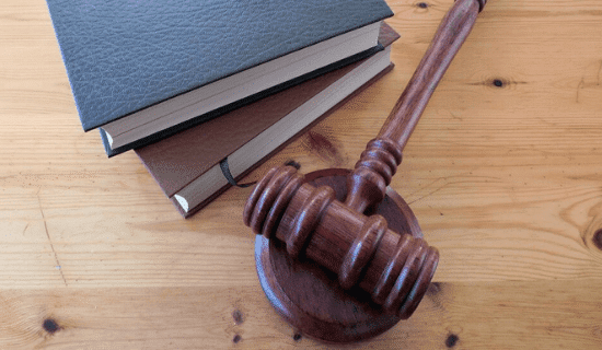 Law books and a gavel on a desk