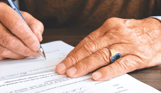 A man signing a document