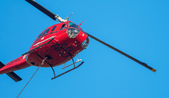 The underside of a red medical helicopter