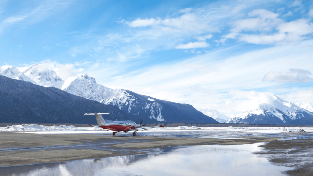 Red and white plane at airport in Haines Alaska