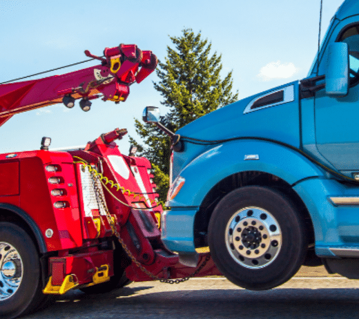 tow truck hauling away a semi